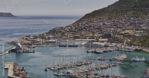 Cape Town South Africa Aerial v91 zoomed flyover Hout Bay Harbor capturing boats docked at the marina, and views of hillside townscape in daytime - Shot with Mavic 3 Pro Cine - Jan 11th 2024
