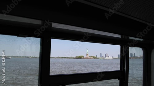 view of statue from staten island ferry (lady liberty freedom symbol in new york harbor) hudson river famous iconic landmark travel tourism destination boat view torch crown