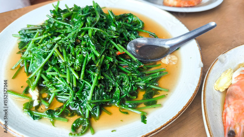 Принти на полотні Stir-fried paco fern with spicy chili and oyster sauce served on white plate, healthy vegetable dish