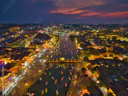 Wallpaper Mural Aerial view of Hoi An old town or Hoian ancient town in sunset. Royalty high-quality free stock image top view of Hoai river and boat night traffic. One of the most popular touristic destinations Torontodigital.ca