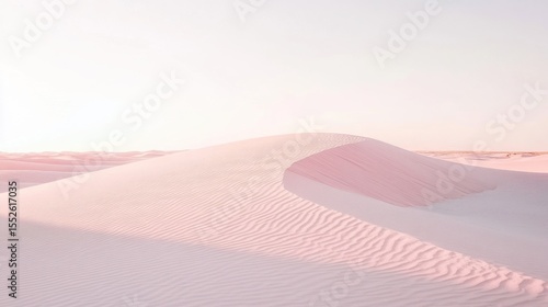 Pastel pink desert dunes under soft sunlight.