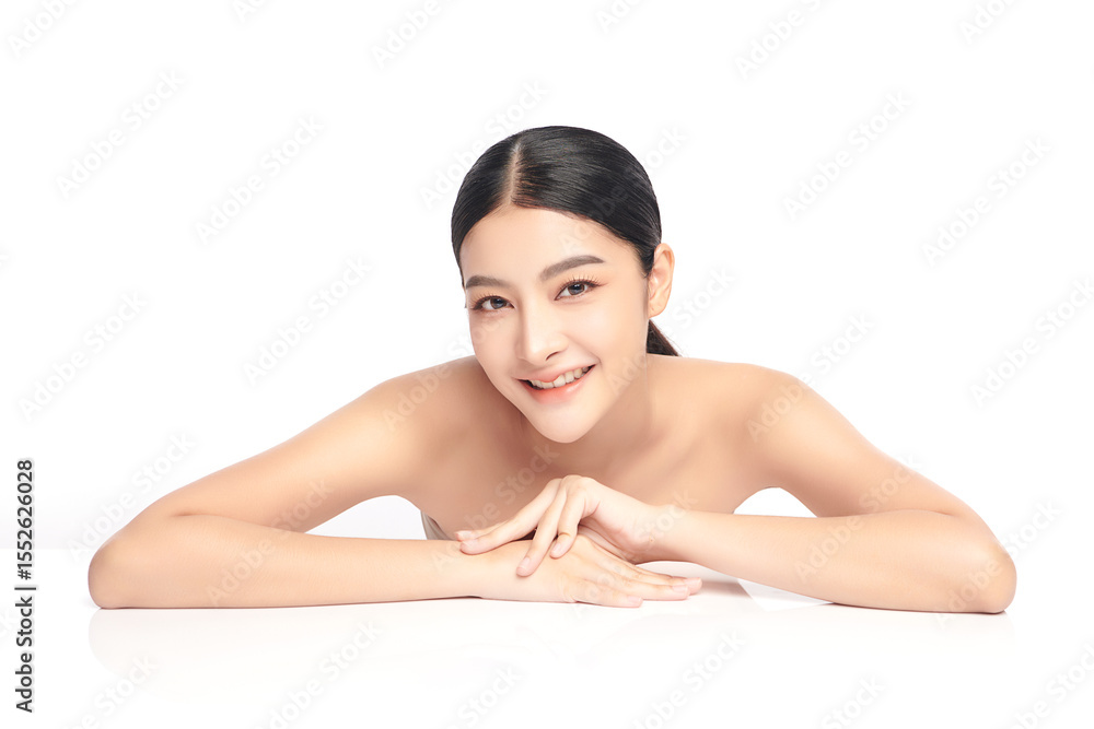 Obraz premium A beautiful young Asian woman with clean, fresh skin against a white background. Skincare, facial treatment, cosmetology, beauty, and spa. An elegant portrait of an Asian woman.