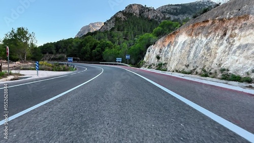 Beautiful winding road with lush greenery and peaceful landscape, perfect for travel and exploration.