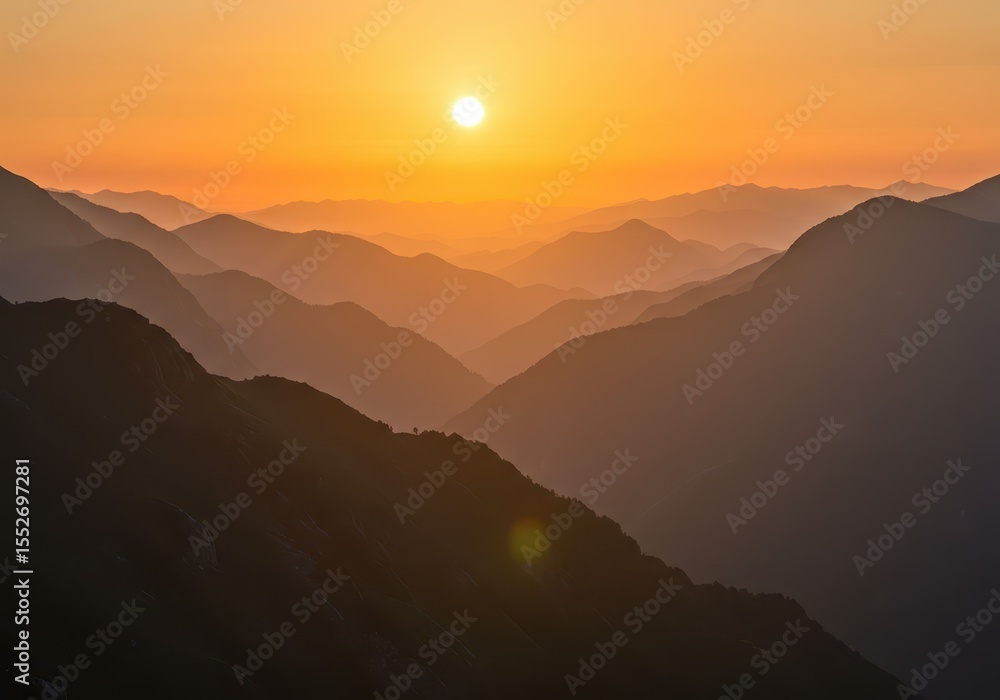 Obraz premium A breathtaking sunset illuminates layers of hazy mountains creating a stunning landscape