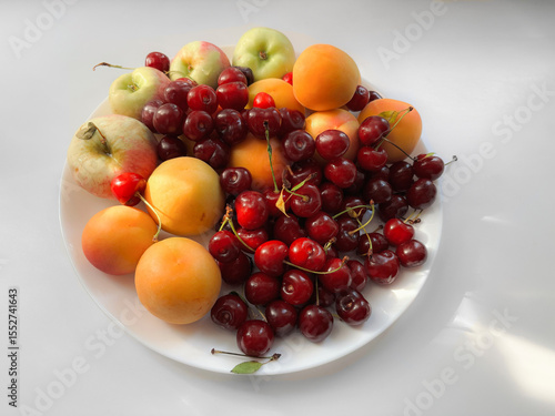 A plate of fruits in the sun
