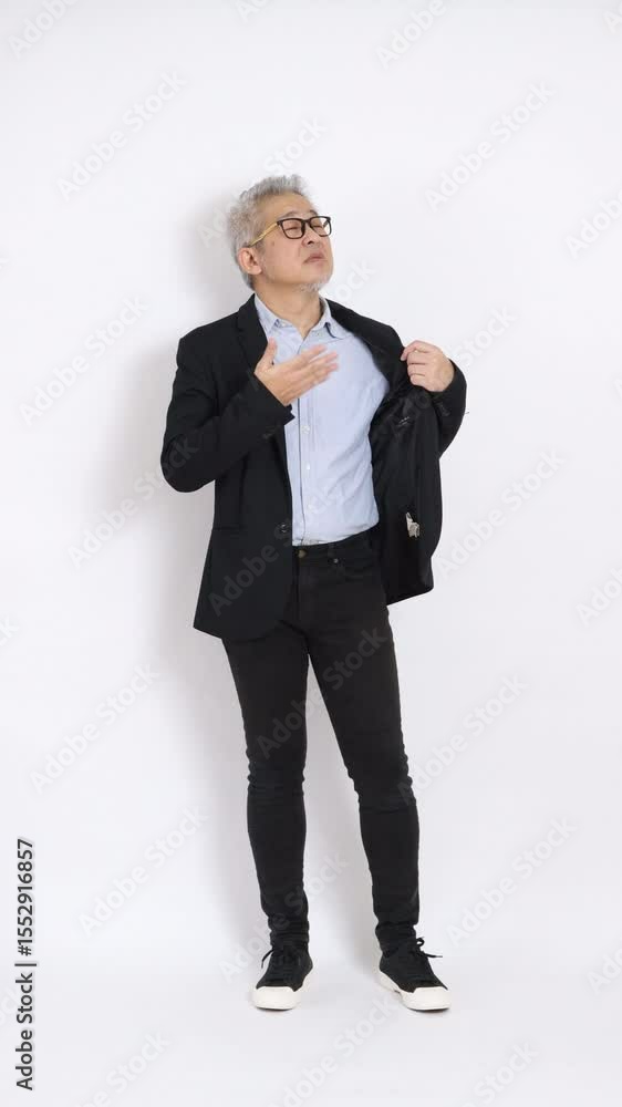 This is a portrait of an East Asian businessman with gray hair and glasses, dressed in a black suit, standing against a white background. This is a portrait of an East Asian businessman with gray hair and glasses, dressed in a black suit, standing against a white background.