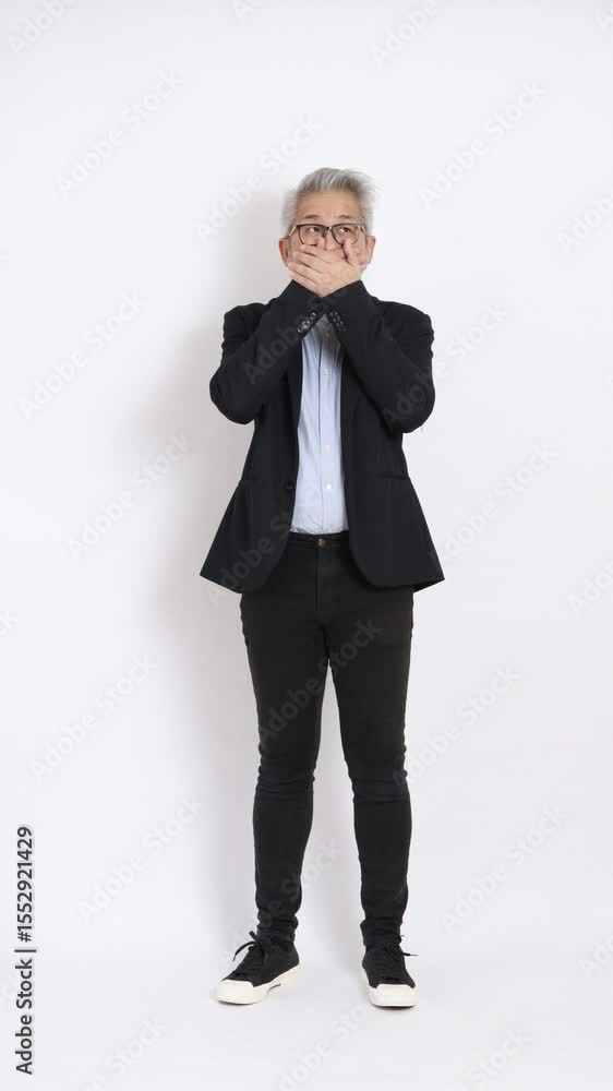 This is a portrait of an East Asian businessman with gray hair and glasses, dressed in a black suit, standing against a white background. This is a portrait of an East Asian businessman with gray hair and glasses, dressed in a black suit, standing against a white background.
