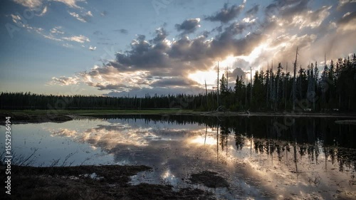Sunset over mountain pond clouds 