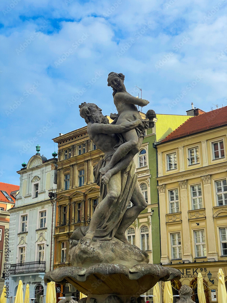 Fototapeta premium Stone sculptures in the historic center of Poznań, Poland. Classical and baroque style statues decorating the architecture of the old town. 