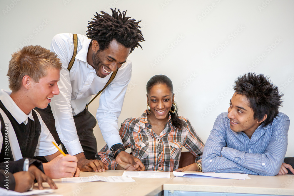 Obraz premium Teenage Students, Working Together. A teacher grading the group work of his class students. From a series of related images.