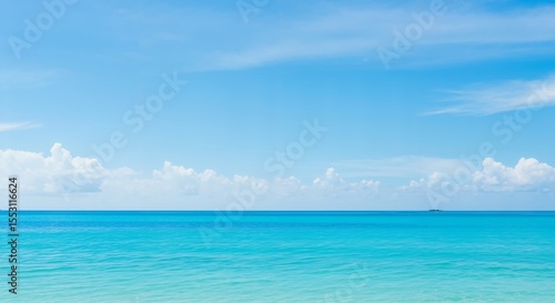 Wallpaper Mural A Serene and Breathtaking Coastal Scene Showcasing a Clear Blue Sky and Tranquil Turquoise Waters Under Gentle White Clouds, Perfect for Relaxation and Inspiration Torontodigital.ca