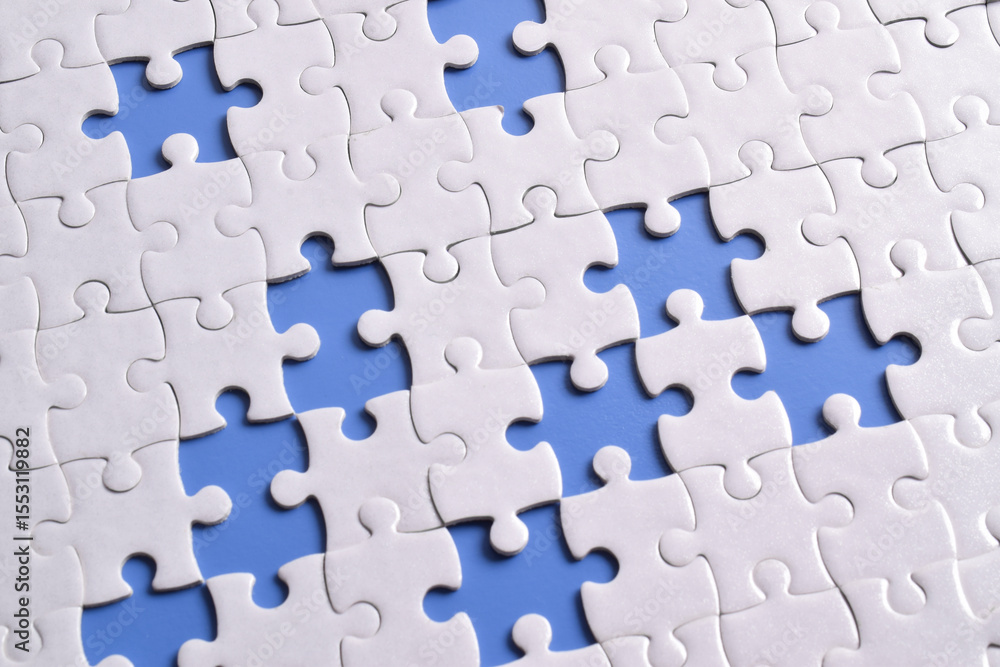 White puzzle with missing piece on blue background, top view White puzzle with missing piece on blue background, top view
