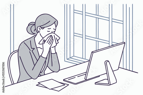 Holding a tissue to her face, the businesswoman sneezes at her office desk, clearly upset by her symptoms.