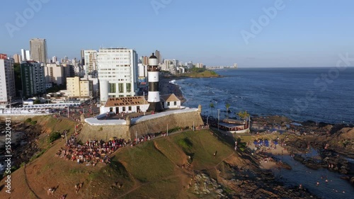 Aerial view of Barra beach and the historic Barra lighthouse, the oldest lighthouse in operation on the coast of Brazil and the Americas, at sunset in Salvador, Bahia, Brazil.	
