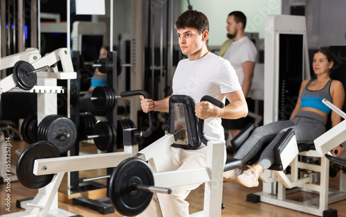 фотографія Guy is training on a back machine