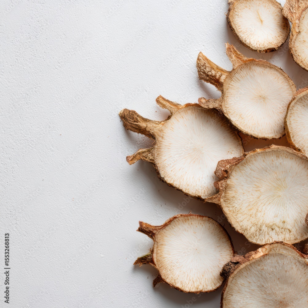 Sliced burdock root botanical arrangement on clean white background natural beauty artistic food photography Sliced burdock root botanical arrangement on clean white background natural beauty artistic food photography