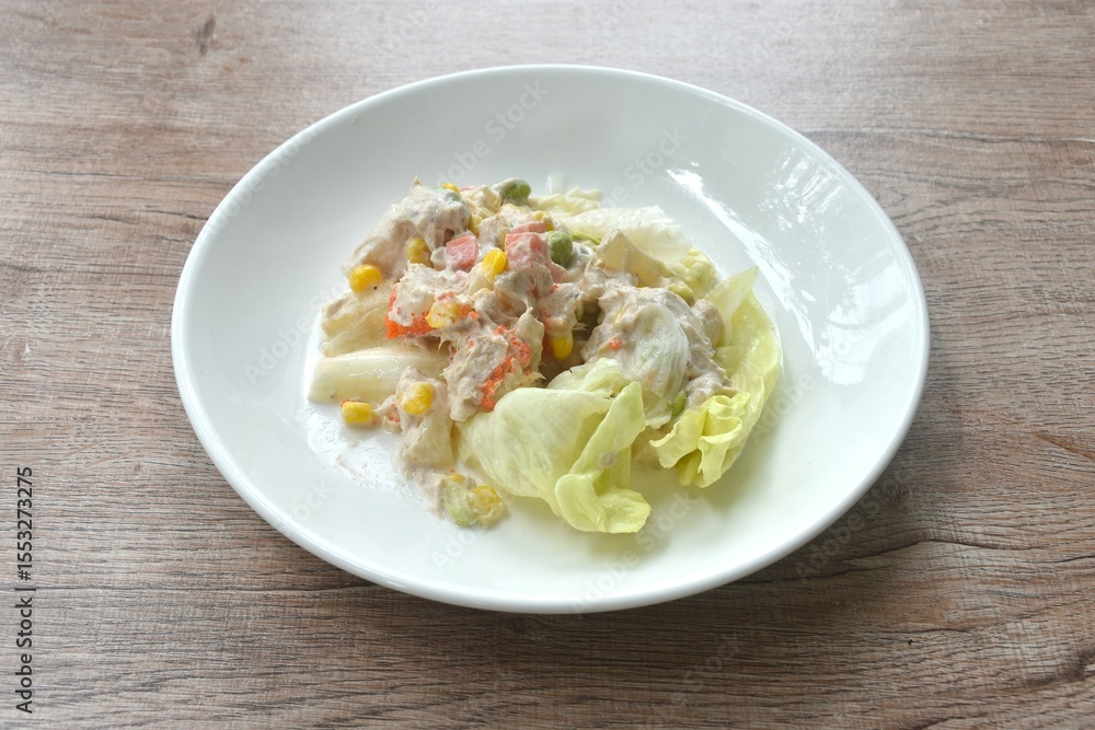 mashed tuna with corn and garden pea couple cabbage vegetable salad dressing cream sauce on plate mashed tuna with corn and garden pea couple cabbage vegetable salad dressing cream sauce on plate