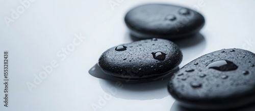 Glistening water droplets cascading over polished black stones, conveying serenity and calm, symbolizing wellness, spa ambiance, meditative tranquility