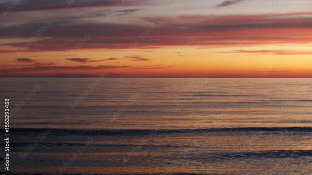 Fototapeta premium Serene sunset over tranquil ocean waves and vibrant sky