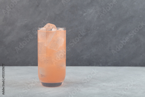 Принти на полотні Grapefruit cocktail with ice cubes in tall drinking glass