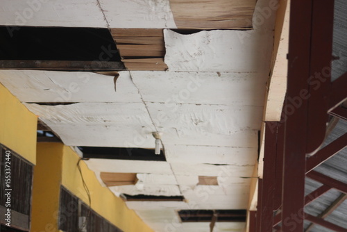 The deck of a building is old and badly damaged,