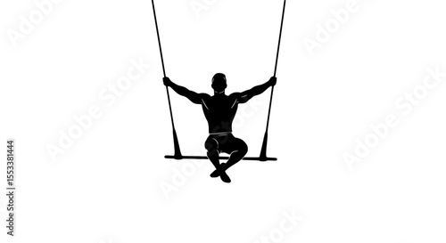Silhouette of a strong athletic person performing a trapeze act suspended mid air showcasing impressive strength and balance during a circus performance