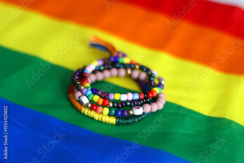 Rainbow friendship bracelets and pride flag. Pride month concept, selective focus.