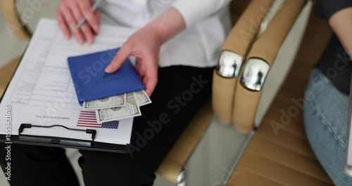 Business people fill visa application forms surrounded by American flags and money during meeting at consulate office. Travel and immigration matters
