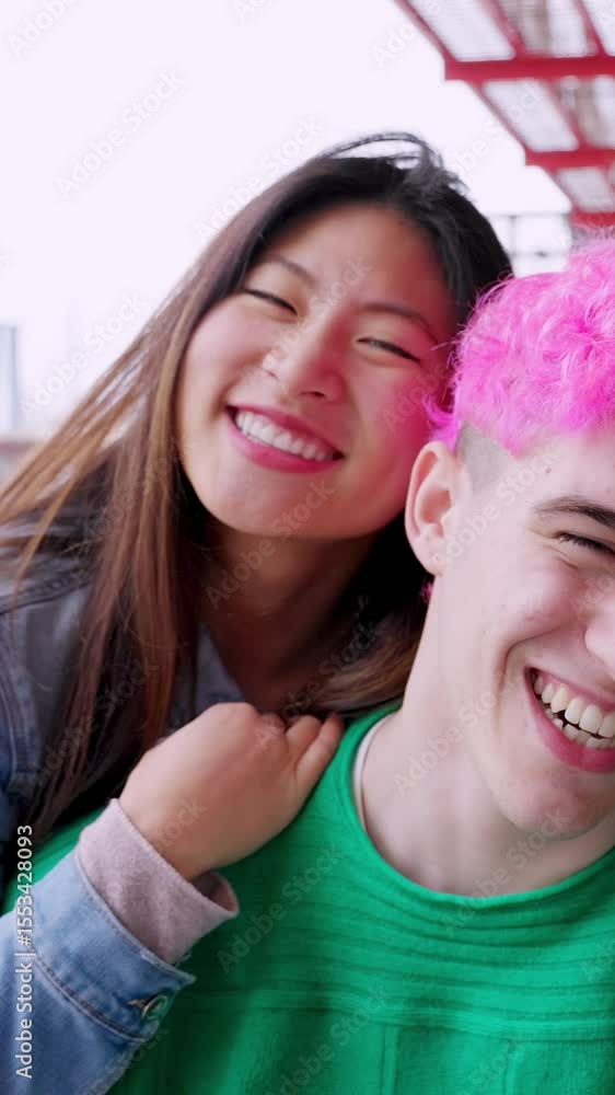 Vertical HD video of diverse young happy people smiling at camera at street. Youth community concept with multiracial friends hugging each other over urban background. Friendship and diversity concept Vertical HD video of diverse young happy people smiling at camera at street. Youth community concept with multiracial friends hugging each other over urban background. Friendship and diversity concept