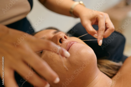 Facial hair removal technique performed by a professional in a calm environment