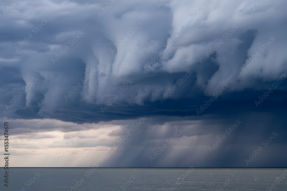 Fototapeta premium Storm clouds bring heavy rain over the ocean horizon