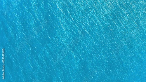 Caribbean sea texture stock video. Sea waves cover landscape. Turquoise sea water and waves 4k background. Blue lagoon surface. Vast ocean background with moderate waves, looking straight down.