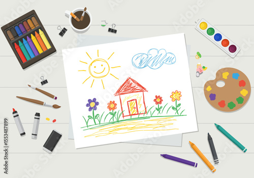 Childs crayon drawing house sun flowers  cloud on paper surrounded by art supplies