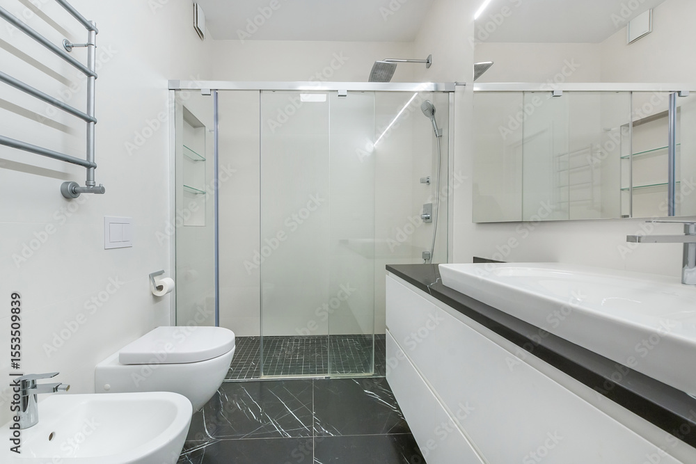 Elegant bathroom design with a walk-in shower and an elegant sink. Bright lighting creates a sense of spaciousness in the room. Elegant bathroom design with a walk-in shower and an elegant sink. Bright lighting creates a sense of spaciousness in the room.