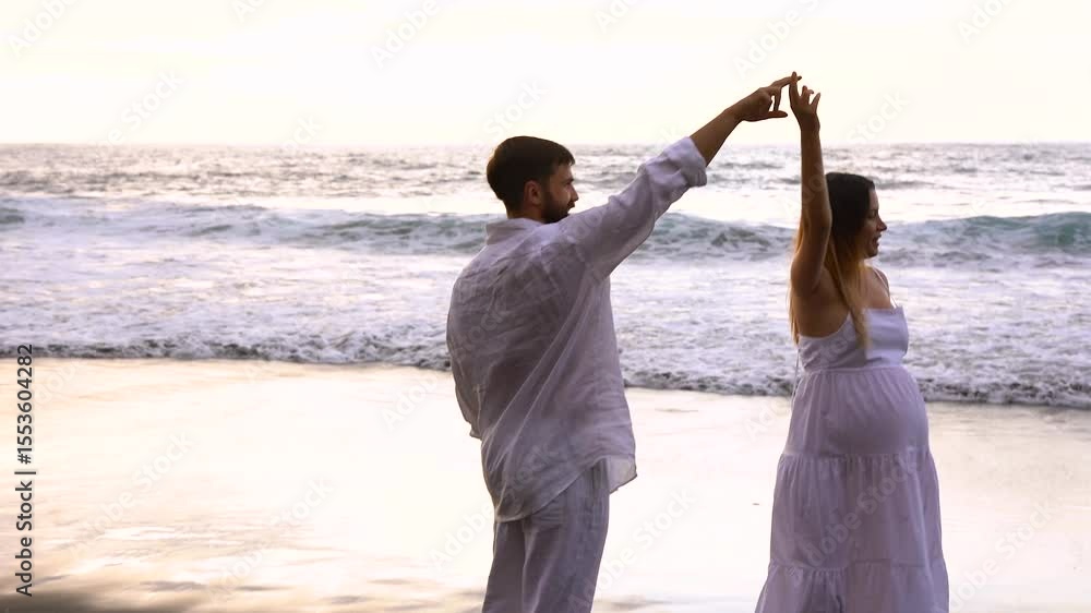 Happy young couple dancing on the beach during summer vacation - Pregnancy, family and parenthood concept Happy young couple dancing on the beach during summer vacation - Pregnancy, family and parenthood concept