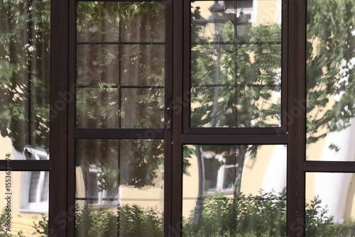Reflections of yellow walls and white windows, street lights in the door glass
