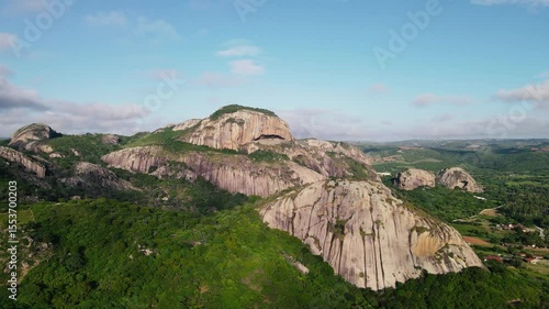 Stunning aerial footage of Pedra da Boca, a unique rock formation located in Paraíba, Brazil. Captured by drone, the video showcases the natural beauty, dramatic cliffs, and lush landscape of this ico
