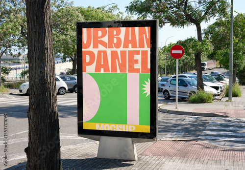 Urban panel mockup stands empty on a street corner, surrounded by parked cars and greenery, ideal for outdoor advertising opportunities. PSD template mockup
