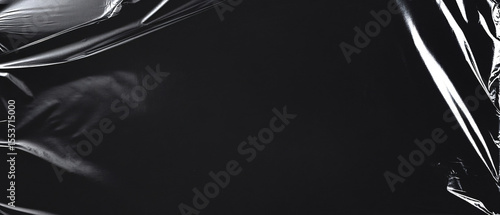 Creased black plastic wrap showcases textures and folds, suitable for overlays