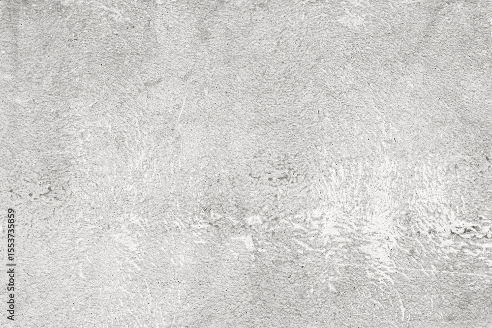 Fototapeta premium A rough white concrete surface with textured irregularities, small pits, and a raw industrial finish