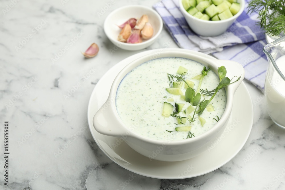 Tasty cucumber soup with dill, microgreens and ingredients on white marble table, closeup Tasty cucumber soup with dill, microgreens and ingredients on white marble table, closeup