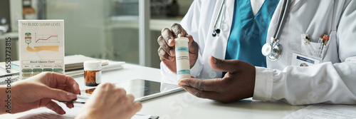 Konstfotografi Black male doctor explaining medication to middle aged Caucasian woman during di