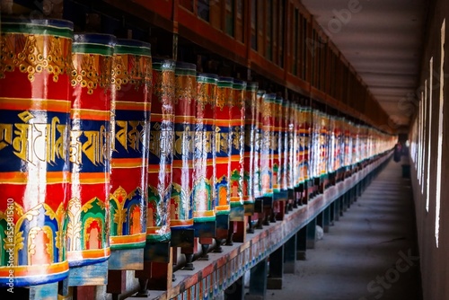 Wallpaper Mural Colorful prayer wheels line a corridor at Kirti Monastery in Ngawa, showcasing Tibetan Buddhist architecture in the historical Amdo region of Tibet. Torontodigital.ca