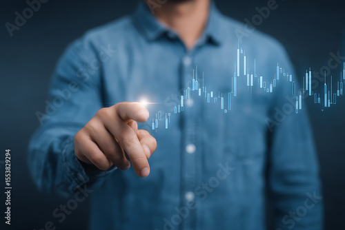 Businessman in Blue Shirt Pointing at Virtual Digital Stock Chart – Modern Technology Interface