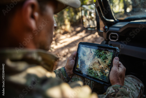 Ranger using ai drone map to monitor deforestation and wildlife zones