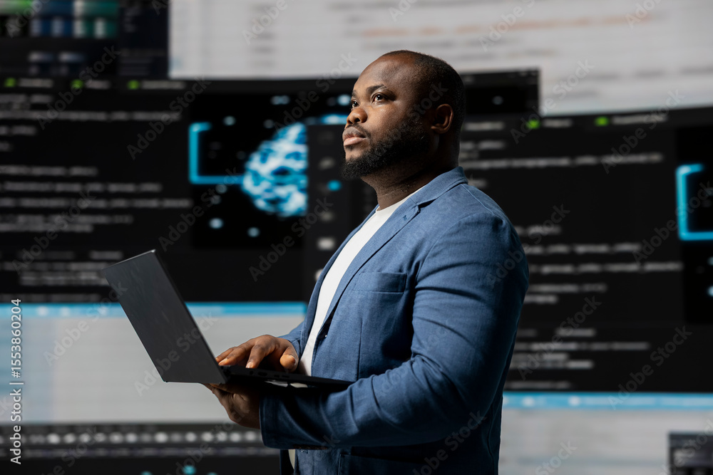 African american coder expert immersing in software development for a high tech work environment, focused on laptop screen. Engineer enjoying coding life and IT cloud computing. African american coder expert immersing in software development for a high tech work environment, focused on laptop screen. Engineer enjoying coding life and IT cloud computing.