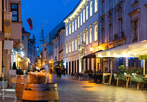Canvas Print Rare passers-by walk along houses on Venturska Street in Bratislava