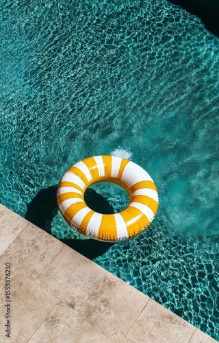Bright Inflatable Ring Floating in a Sparkling Swimming Pool on a Sunny Day