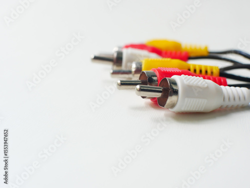 RCA cable with red, yellow, and white connectors, used for audio and video connections, isolated on a white background.