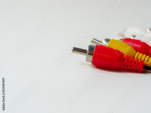 RCA cable with red, yellow, and white connectors, used for audio and video connections, isolated on a white background.